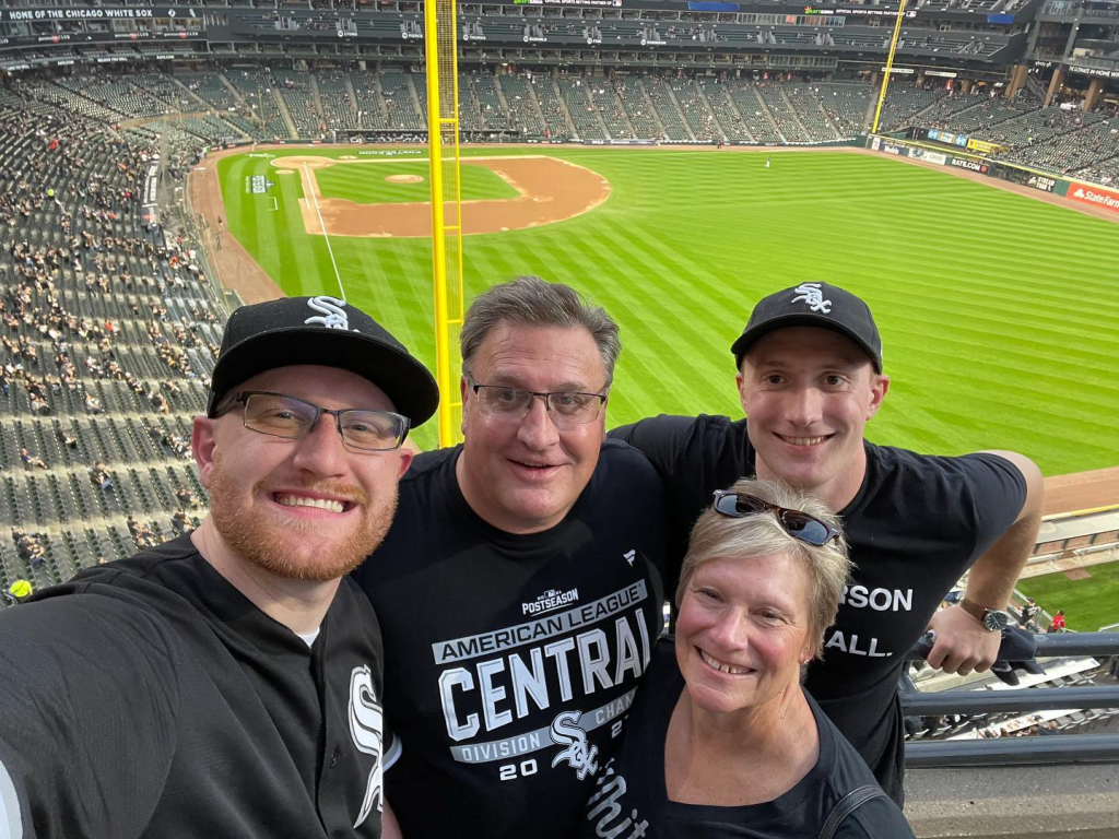 Drew Bogs taking a with his family at Guaranteed Rate field, the field is behind them